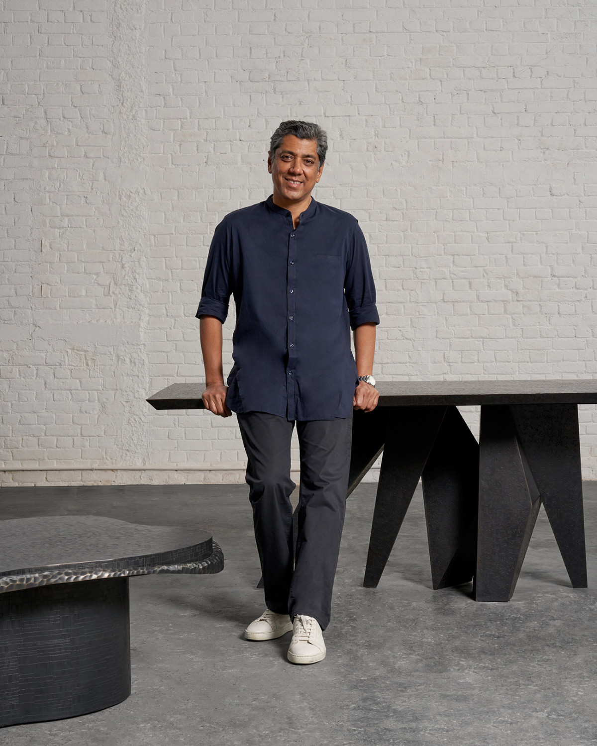 Vikram Goyal na tle autorskiego projektu – stołu jadalnego o asymetrycznych nogach